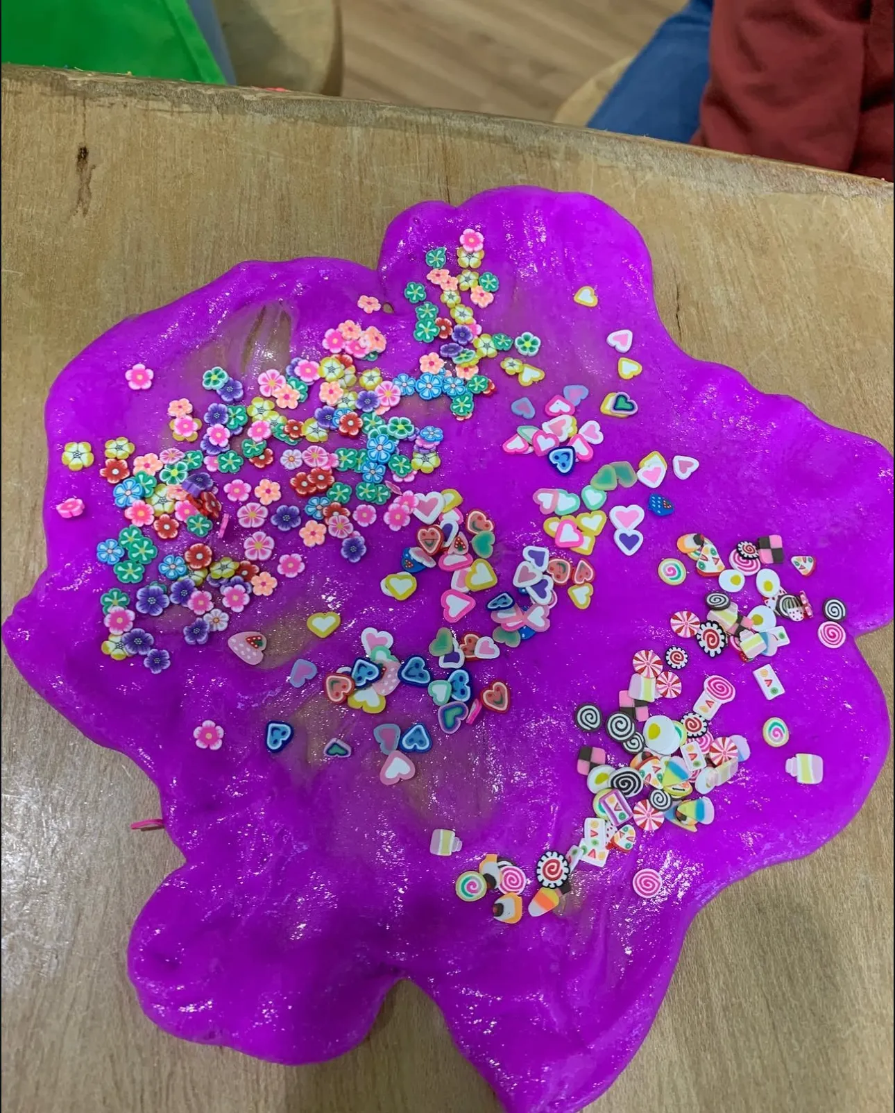 Purple slime decorated with colourful flowers, hearts and sweets